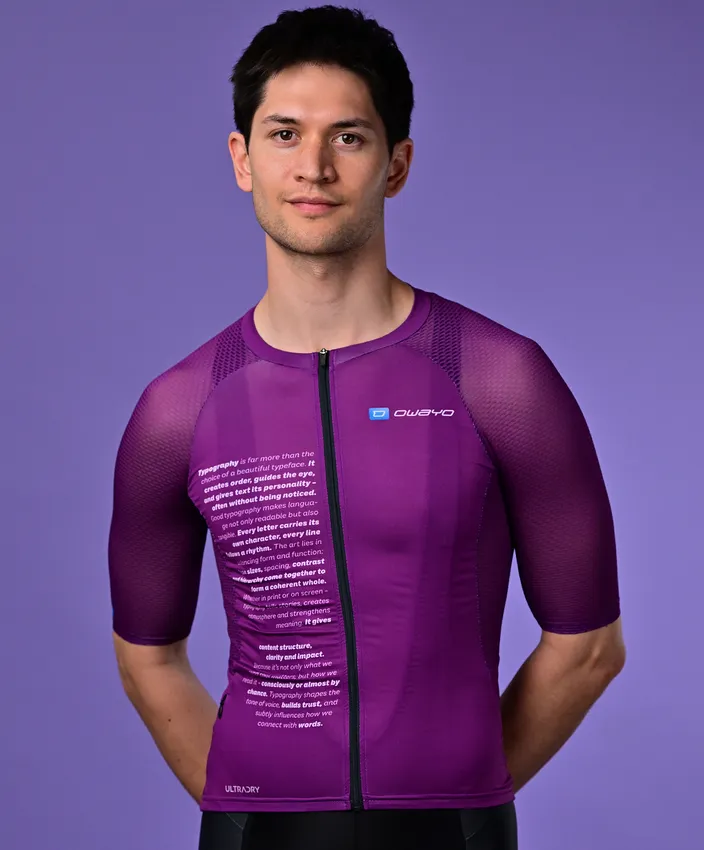A man wearing a purple, short-sleeved sport jersey from owayo with text on the chest and the owayo logo on the right chest.